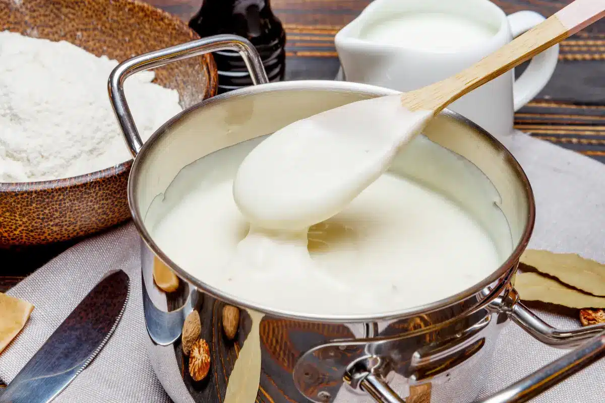 Creamy Bitchin' Sauce in a bowl with vegetable sticks and chips.