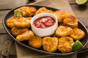 Golden-brown crispy corn nuggets with dipping sauce