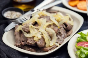 Cooked beef liver with onions and herbs