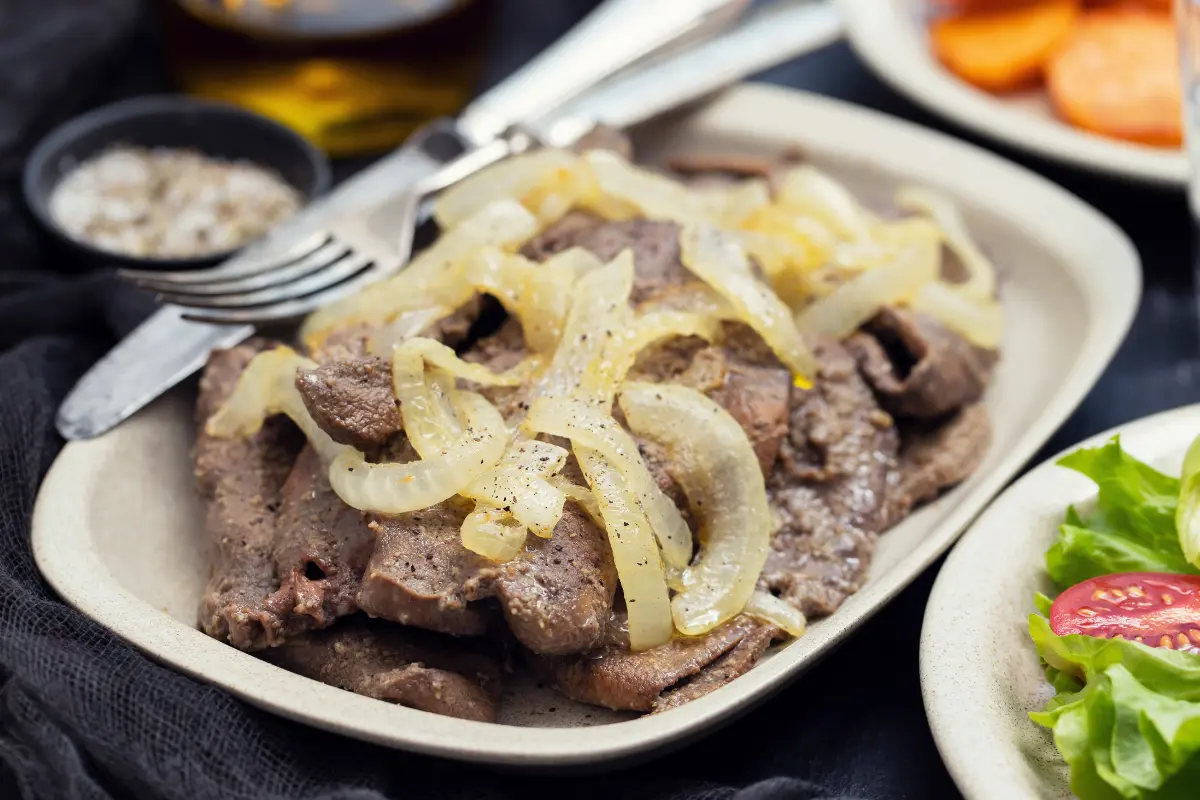 Cooked beef liver with onions and herbs