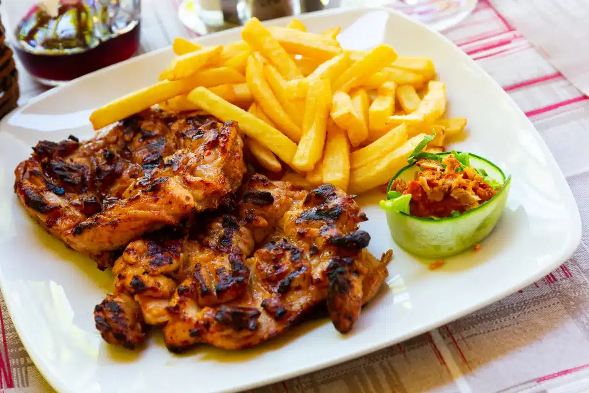 Juicy grilled chicken thighs with perfect grill marks on a wooden board