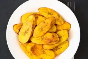 Golden caramelized Platanos Maduros on a plate.