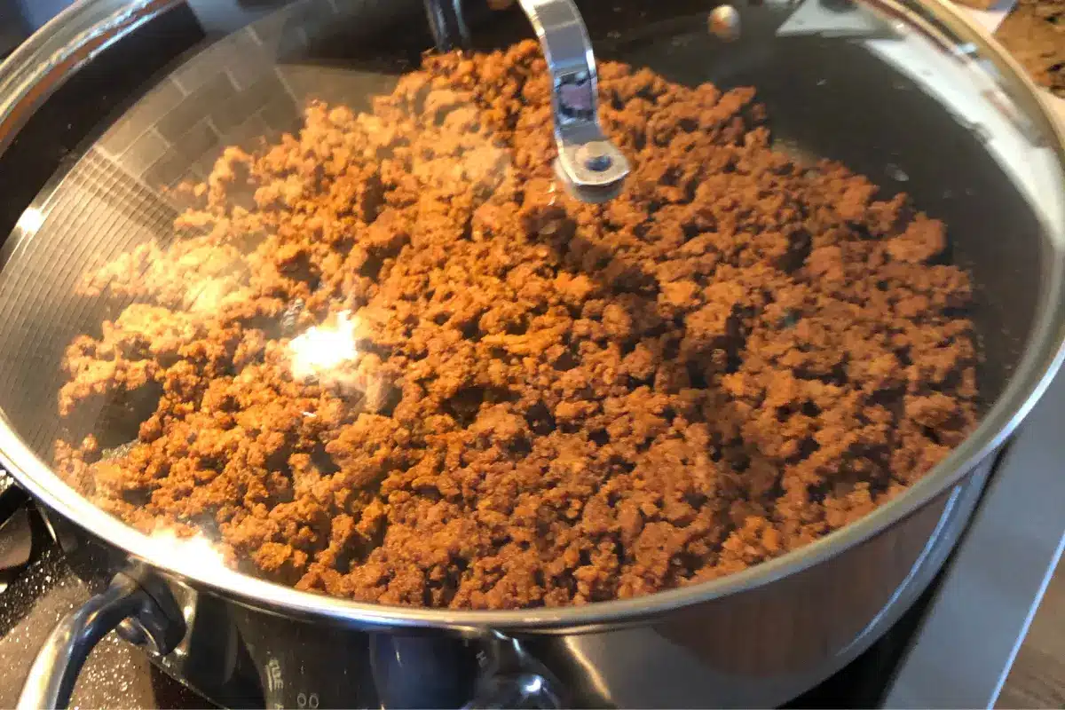 "Taco meat in a skillet, seasoned to perfection."