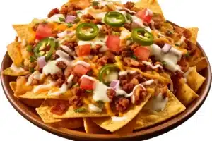 Plate of loaded nacho fries with cheese and toppings.