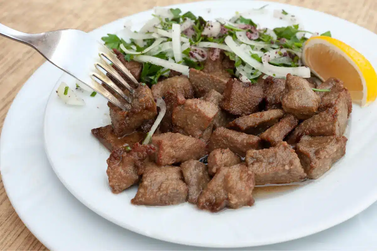 Cooked beef liver with onions and herbs