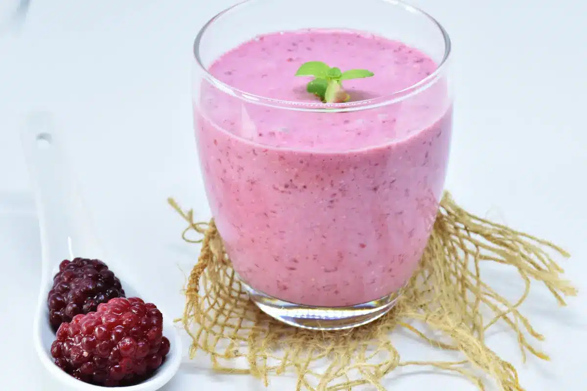 Homemade Grimace Shake with whipped cream topping and purple sprinkles