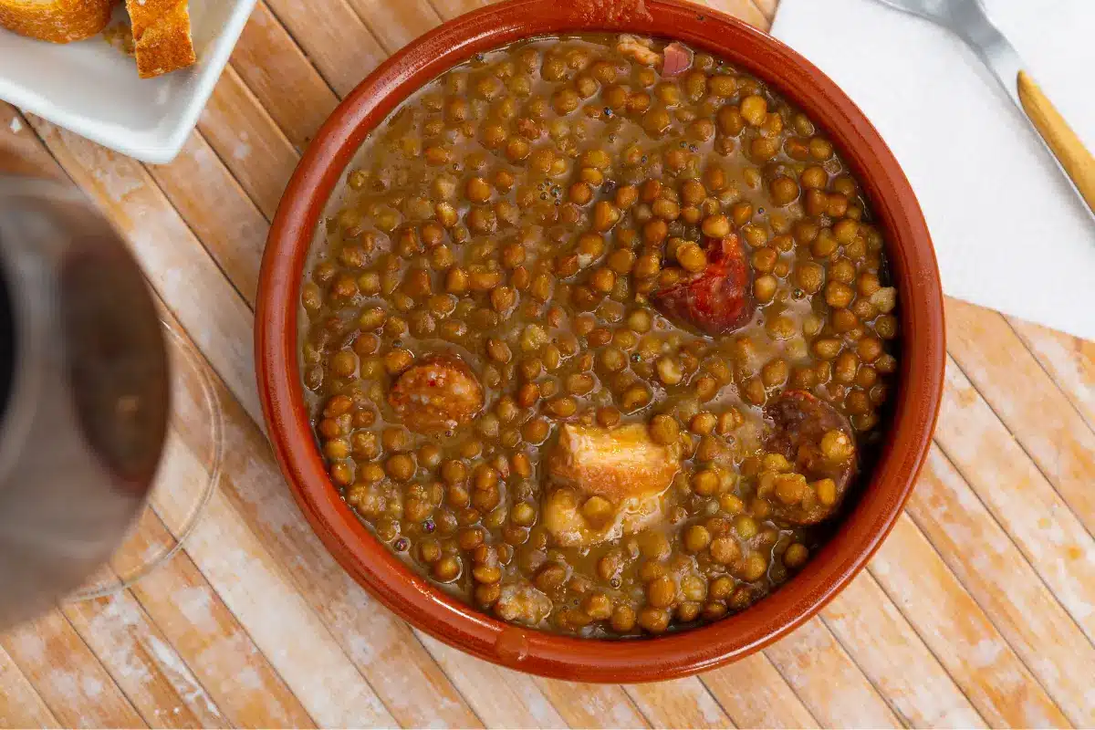 Bowl of homemade lentejas with vegetables and spices.