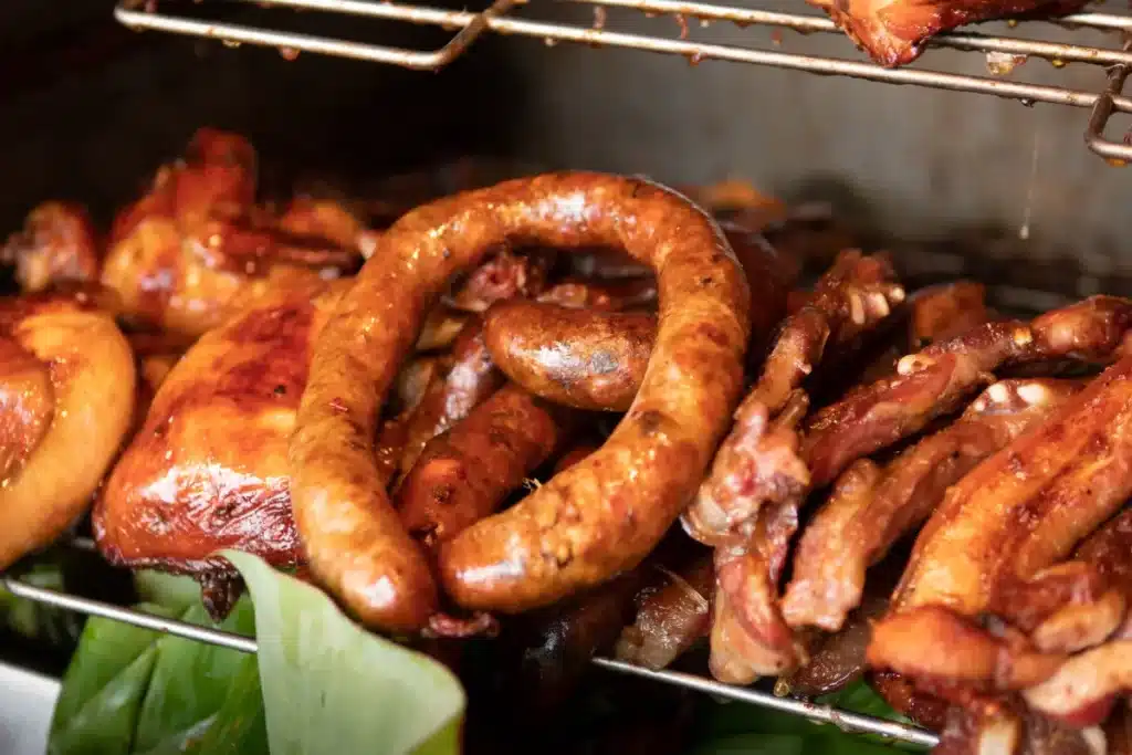 Fresh homemade chicken sausage on a wooden board.