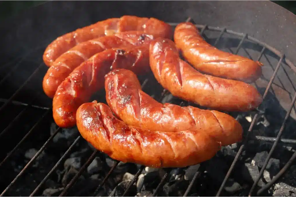 Fresh homemade chicken sausage on a wooden board.